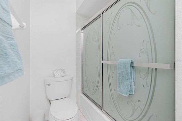 bathroom featuring shower / bath combination with glass door and toilet