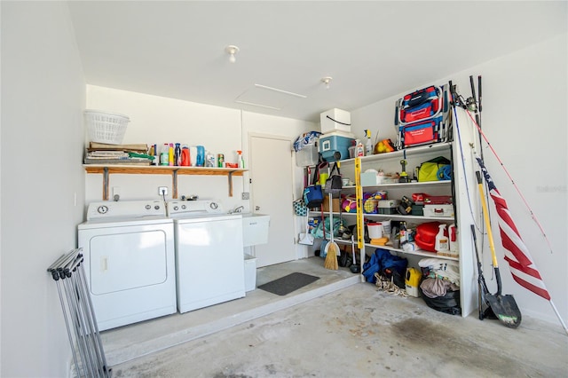 laundry area with separate washer and dryer and sink