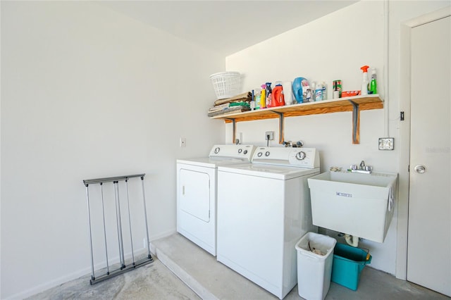 laundry area with washer and clothes dryer and sink