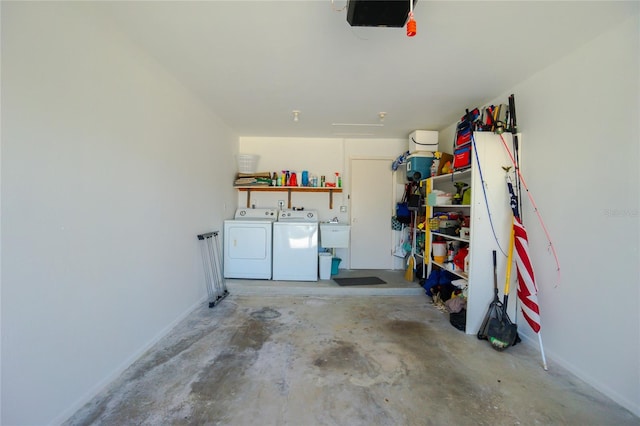 garage featuring washing machine and dryer and a garage door opener