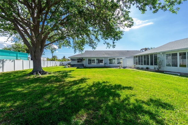 rear view of property featuring a yard