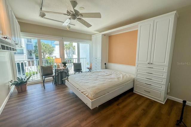 bedroom with ceiling fan, track lighting, dark wood-type flooring, and a textured ceiling