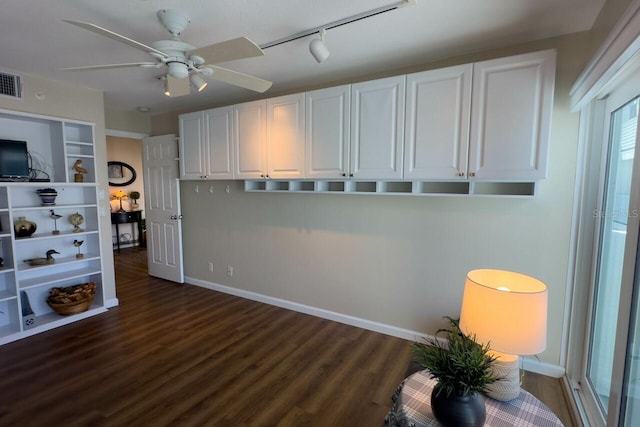 interior space featuring white cabinets, ceiling fan, dark wood-type flooring, and rail lighting