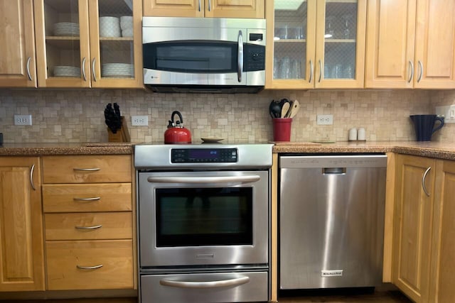 kitchen featuring appliances with stainless steel finishes and tasteful backsplash