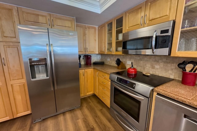 kitchen with light brown cabinetry, dark hardwood / wood-style flooring, stainless steel appliances, and tasteful backsplash