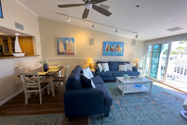 living room featuring plenty of natural light, ceiling fan, lofted ceiling, and rail lighting