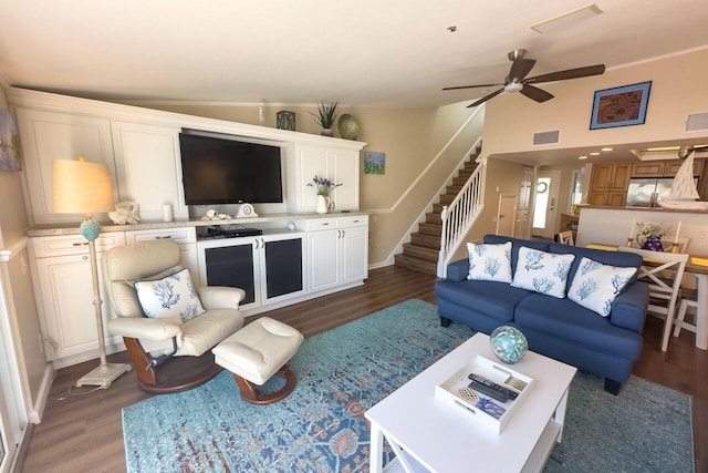 living room featuring dark hardwood / wood-style floors, ceiling fan, and lofted ceiling