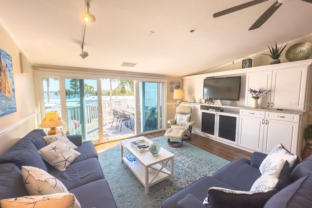 living room with ceiling fan, hardwood / wood-style floors, a healthy amount of sunlight, and lofted ceiling