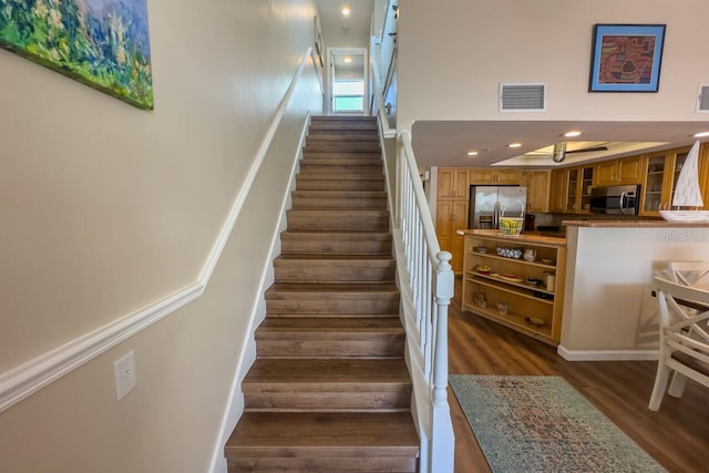 staircase with wood-type flooring