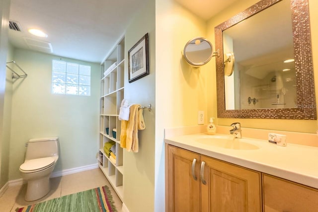 bathroom with toilet, vanity, tile patterned floors, and walk in shower