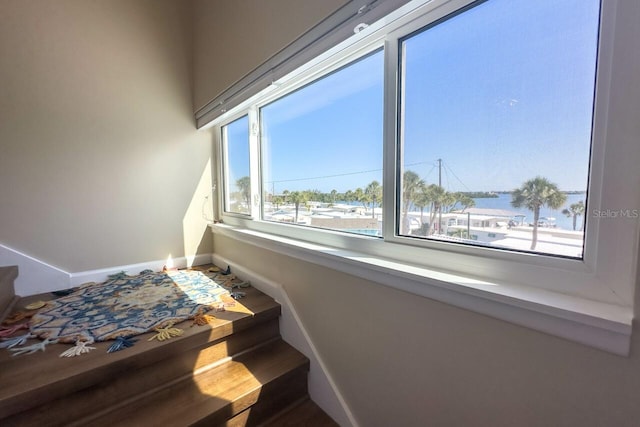 stairs with a water view and a healthy amount of sunlight