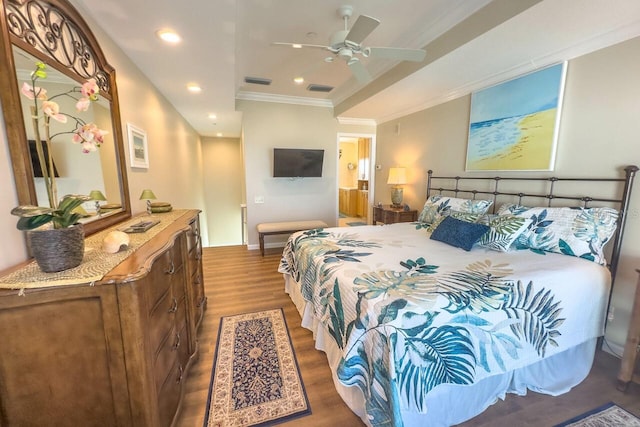 bedroom with hardwood / wood-style floors, connected bathroom, ceiling fan, and crown molding