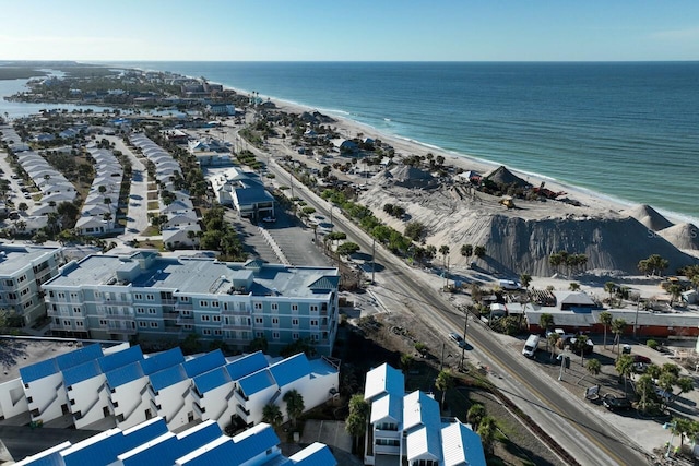 bird's eye view with a water view and a beach view