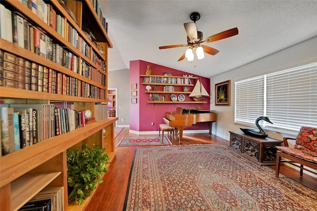 office area featuring a textured ceiling, hardwood / wood-style flooring, ceiling fan, and lofted ceiling