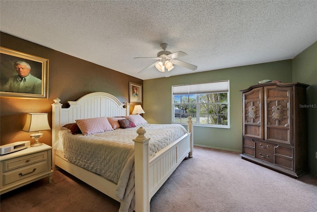 bedroom featuring carpet flooring, ceiling fan, and a textured ceiling