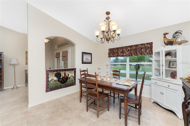 dining room featuring arched walkways, an inviting chandelier, baseboards, and vaulted ceiling