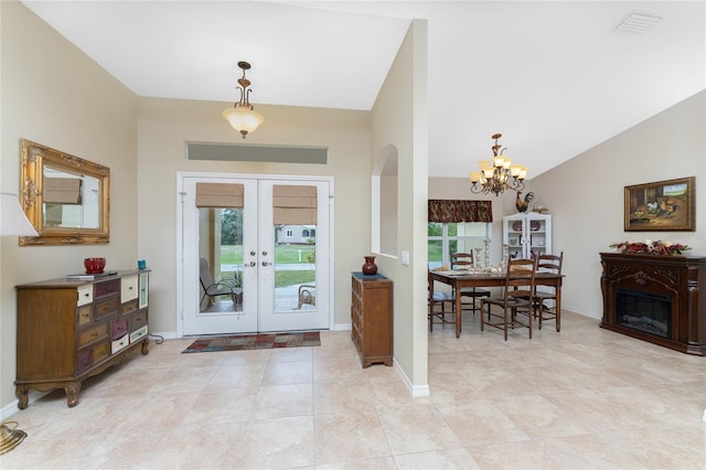 foyer entrance featuring visible vents, french doors, baseboards, and lofted ceiling