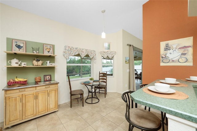 dining area featuring light tile patterned floors and baseboards