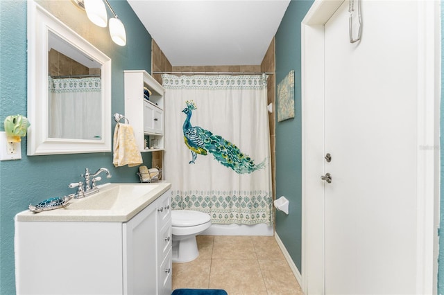 bathroom with tile patterned flooring, toilet, and vanity