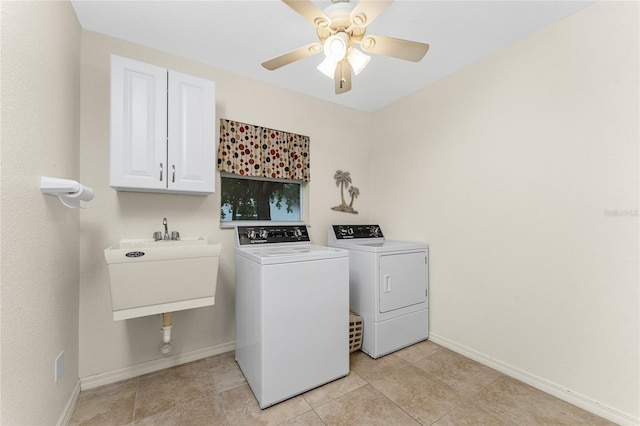 washroom with washer and dryer, cabinet space, baseboards, and a sink