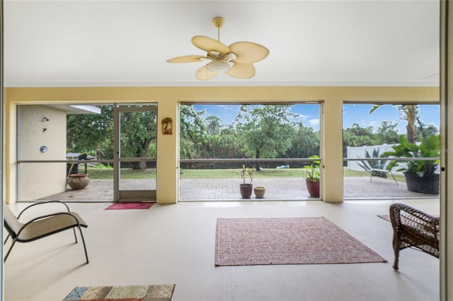 sunroom / solarium with plenty of natural light and a ceiling fan