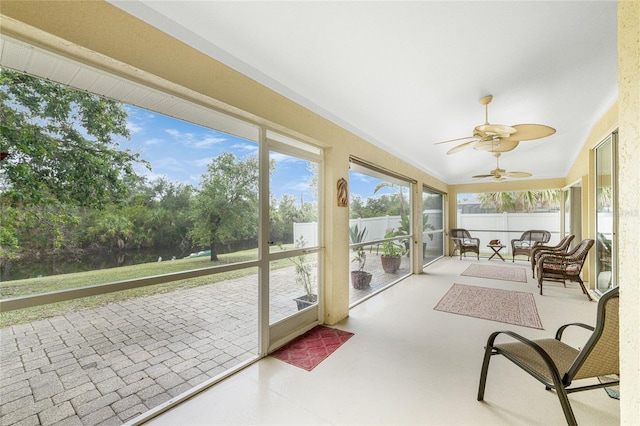 sunroom / solarium with vaulted ceiling and a ceiling fan