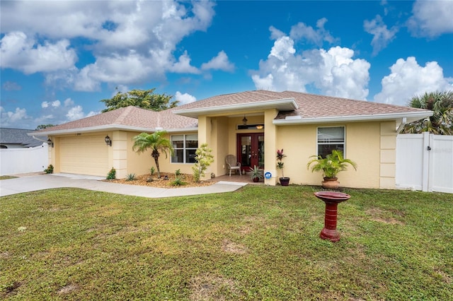 view of front facade featuring stucco siding, driveway, a gate, fence, and a front yard