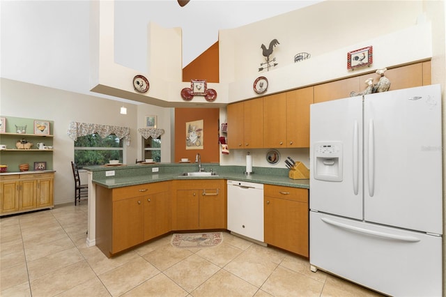 kitchen featuring a peninsula, light tile patterned flooring, white appliances, high vaulted ceiling, and a sink