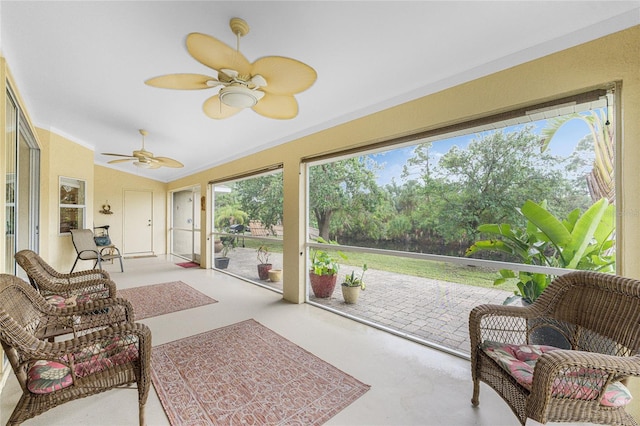 sunroom featuring ceiling fan and vaulted ceiling