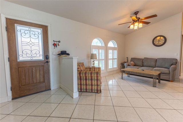 living room with ceiling fan, light tile patterned flooring, and vaulted ceiling