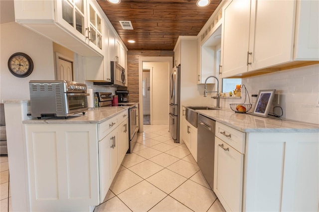 kitchen featuring wooden ceiling, white cabinets, sink, light tile patterned flooring, and stainless steel appliances