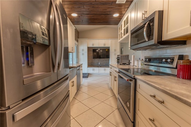 kitchen with white cabinetry, wooden ceiling, vaulted ceiling, light tile patterned floors, and appliances with stainless steel finishes