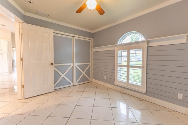 empty room with light tile patterned floors and ceiling fan