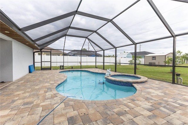 view of pool with an in ground hot tub, a yard, glass enclosure, and a patio area