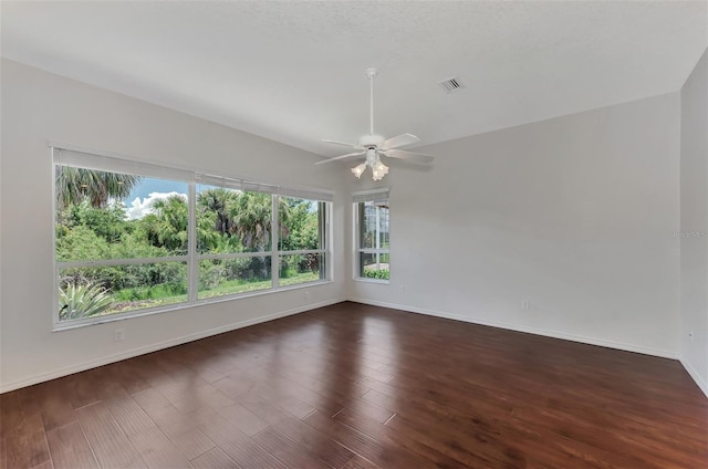 unfurnished room featuring dark hardwood / wood-style floors and ceiling fan