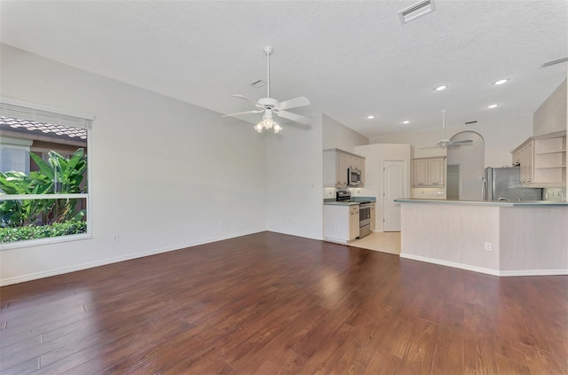 unfurnished living room with lofted ceiling, ceiling fan, light hardwood / wood-style floors, and a textured ceiling