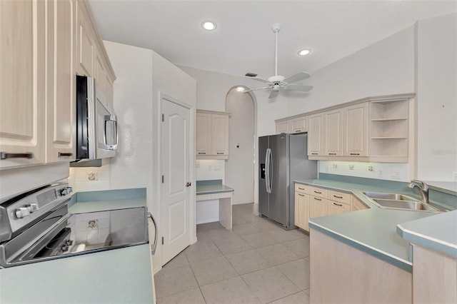 kitchen featuring ceiling fan, sink, light brown cabinetry, light tile patterned floors, and appliances with stainless steel finishes