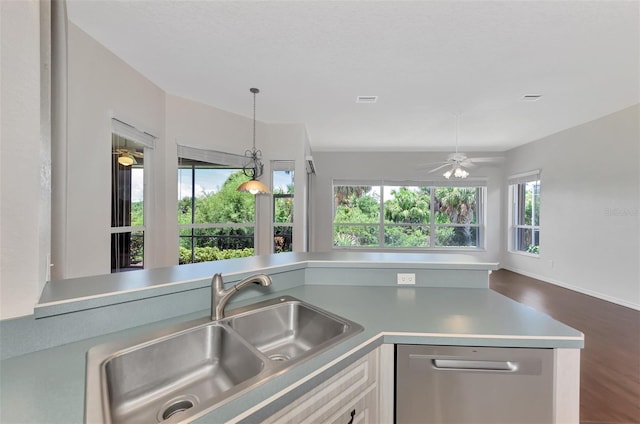 kitchen with pendant lighting, dark wood-type flooring, sink, stainless steel dishwasher, and ceiling fan