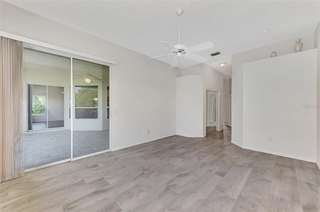 unfurnished room with lofted ceiling, ceiling fan, and light wood-type flooring