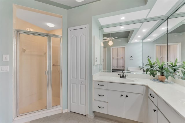 bathroom featuring walk in shower, vanity, tile patterned floors, and ceiling fan