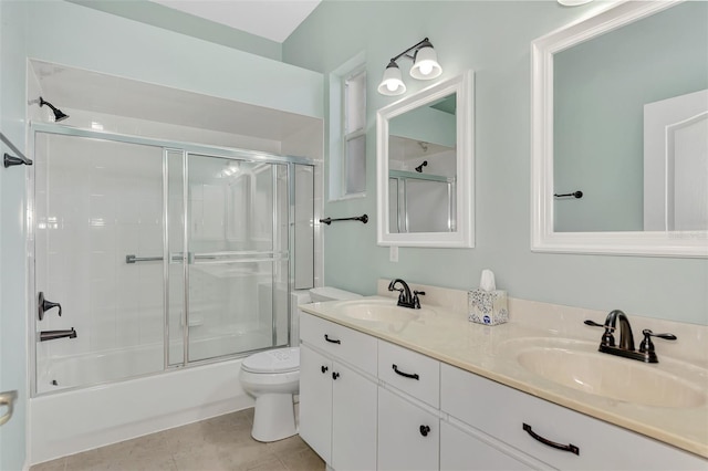 full bathroom with shower / bath combination with glass door, tile patterned floors, vanity, and toilet