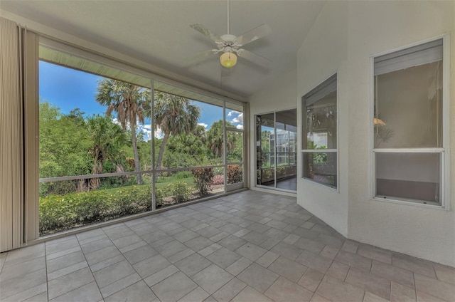 unfurnished sunroom with ceiling fan