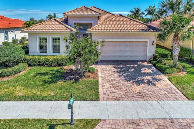 mediterranean / spanish house with a front yard and a garage