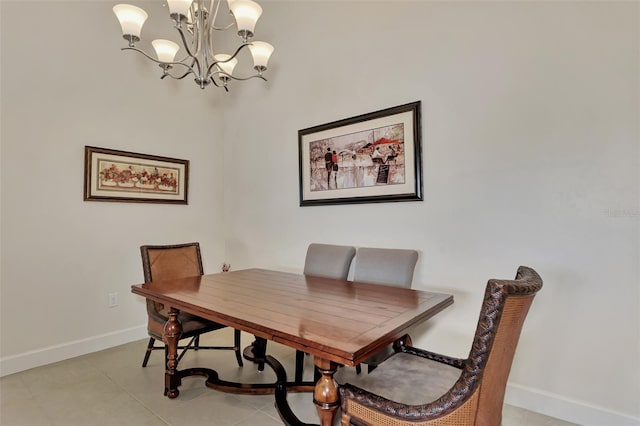 tiled dining room with a chandelier