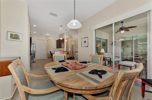 dining space with ceiling fan and light tile patterned flooring