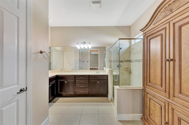 bathroom featuring tile patterned flooring, vanity, and a shower with door