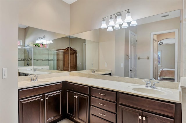 bathroom featuring ceiling fan, an enclosed shower, and vanity