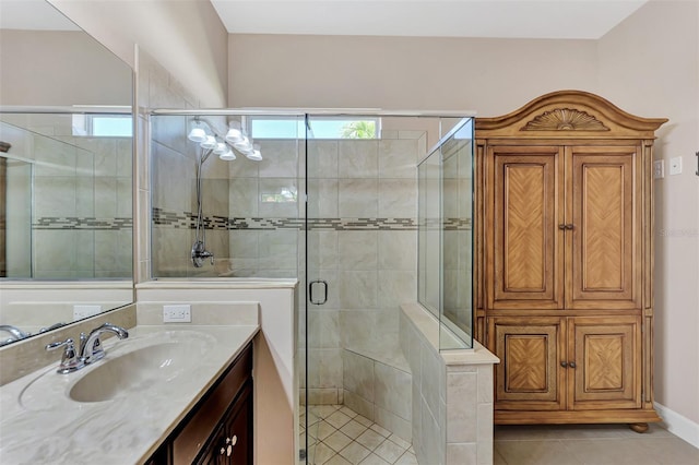 bathroom with tile patterned floors, vanity, a healthy amount of sunlight, and walk in shower