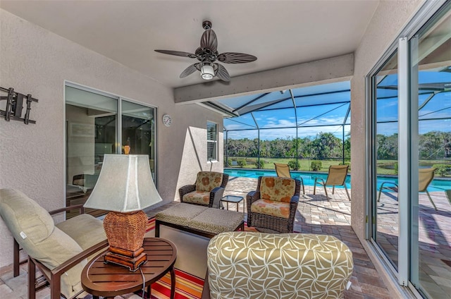 view of patio / terrace with a lanai, ceiling fan, and an outdoor hangout area