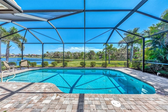 view of swimming pool with glass enclosure, a patio area, and a water view